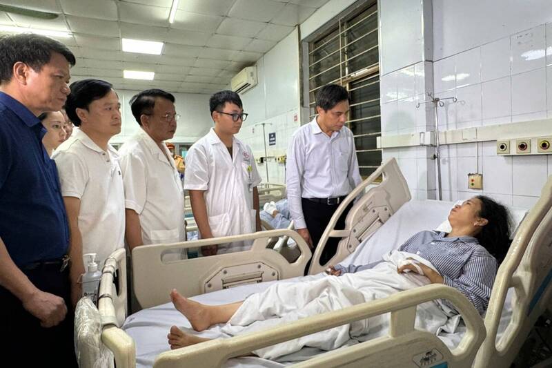 越南广宁省官员前往当地医院探望下龙湾船难事件的幸存者。（欧新社）